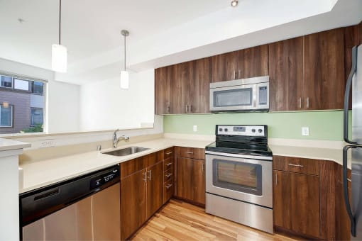 a kitchen with stainless steel appliances and wooden cabinets