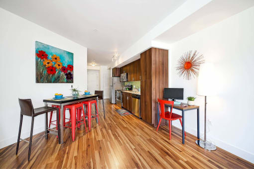 a living room with a table and chairs and a kitchen