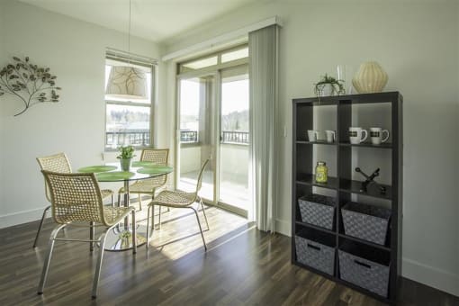 a dining room with a table and chairs and a window