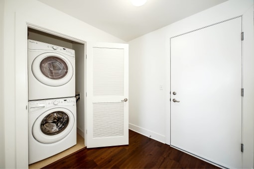 a white laundry room with a washer and dryer in it