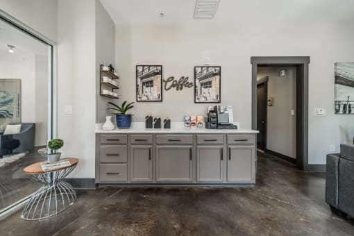 a kitchen with a counter and a door to a living room