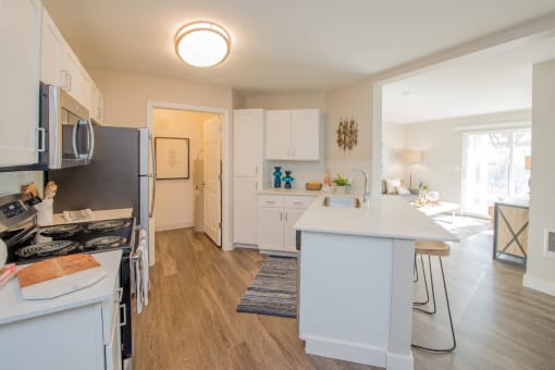 a kitchen with a white counter top and a refrigerator