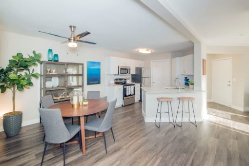 a living room and kitchen with a table and chairs