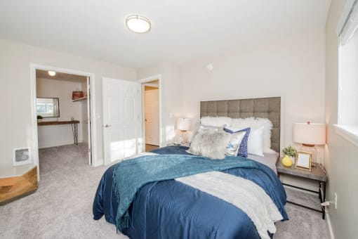 a bedroom with a bed and a door to a bathroom