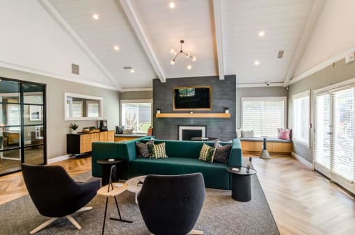 a living room with a green couch and a fireplace