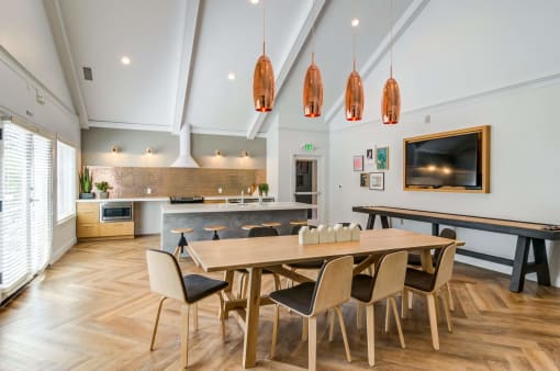 a dining room with a wooden table and chairs