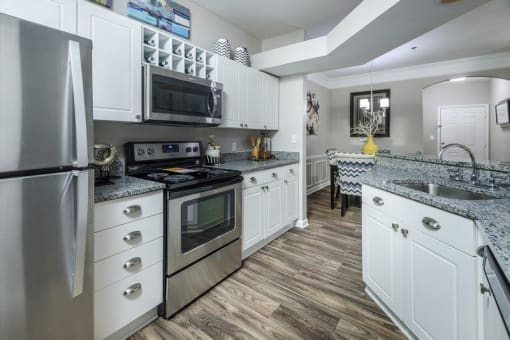 a kitchen with stainless steel appliances and white cabinets