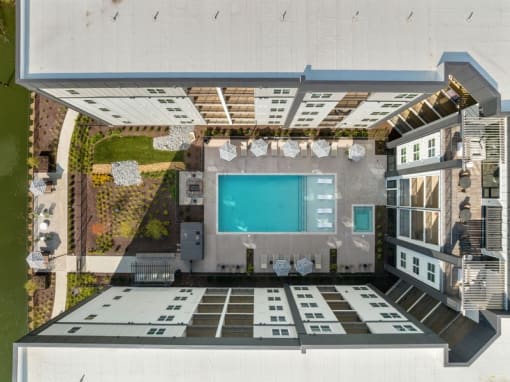 an aerial view of a swimming pool on the roof of a house