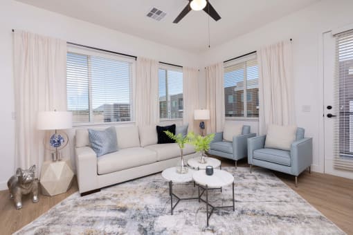 spacious living room with large windows and ceiling fan at Element 12 Apartments, Henderson NV