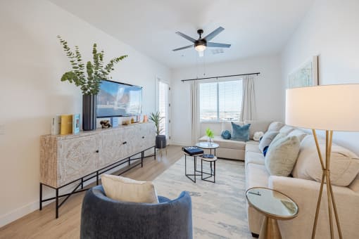 a living room with white furniture and a ceiling fan at Element 12 Apartments, Henderson NV
