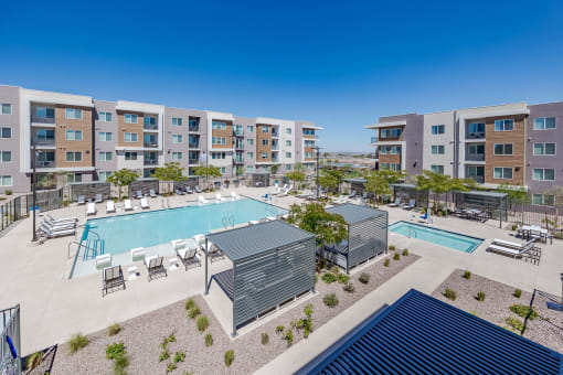 a view of a pool with an apartment building in the background at Element 12 Apartments, Henderson NV