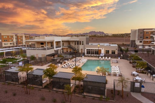 an aerial view of a pool and buildings at sunset at Element 12 Apartments, Henderson NV