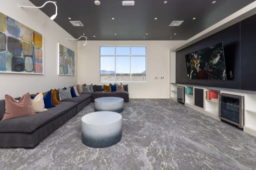 a living room with couches and a fireplace and a tv at Element 12 Apartments, Henderson NV