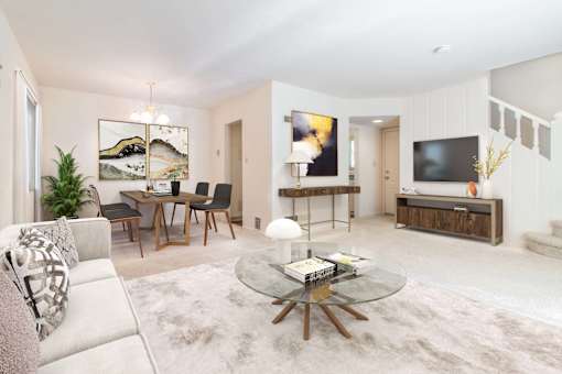 A modern living room with a glass coffee table and a white sofa at Hillsdale Garden Apartments, CA, 94403