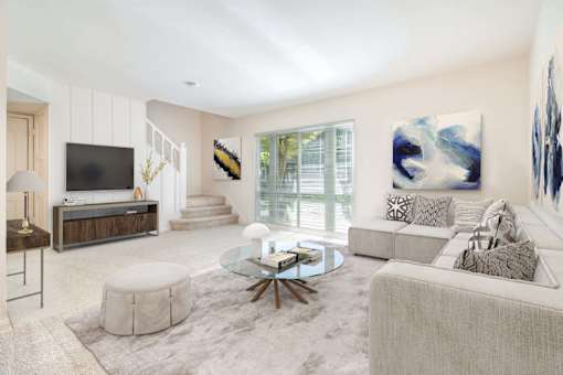 a living room with a couch and a tv at Hillsdale Garden Apartments, San Mateo, CA