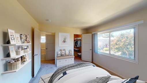 One-Bedroom Affordable Apartments in San Mateo, CA - Hillsdale Garden - Bedroom with a Walk-in Closet, Exposed Shelves, and Natural Lighting at Hillsdale Garden Apartments, San Mateo, California