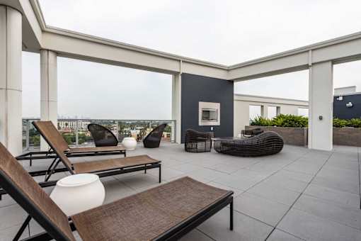 A patio with a table, chairs, and a couch.