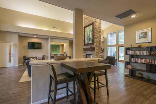 A dining room with a wooden table and chairs.