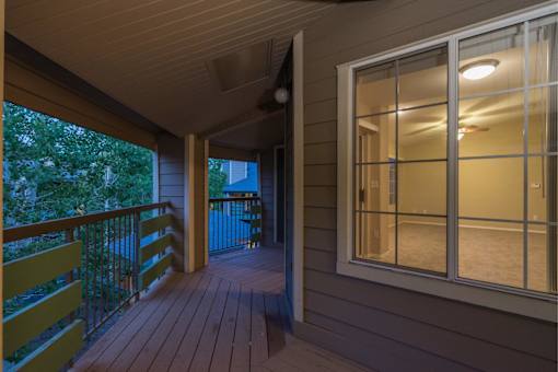 A balcony with a railing and a window.