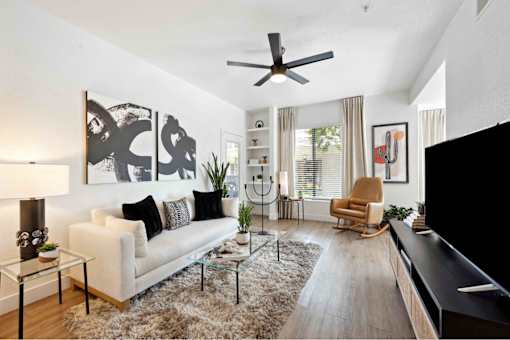a living room with a white couch and a large window