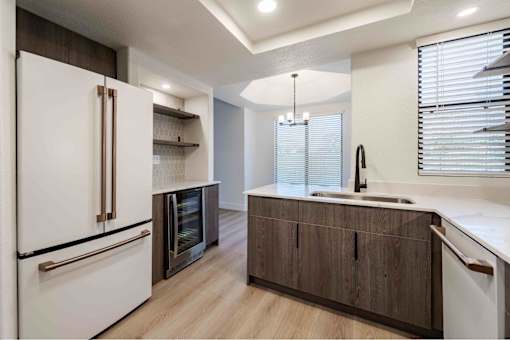 a kitchen with a sink and a refrigerator