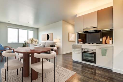 A modern kitchen with a dining table and chairs.