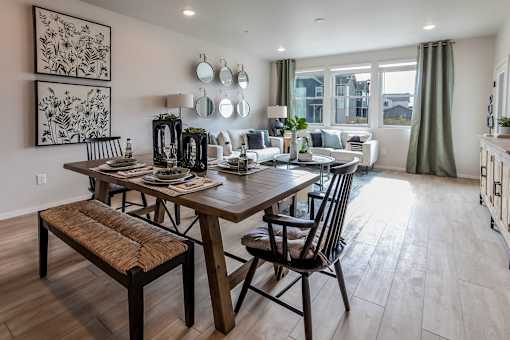 A dining room with a wooden table and chairs.