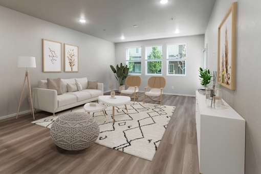 A modern living room with a white sofa, a round ottoman, and a large abstract painting on the wall.