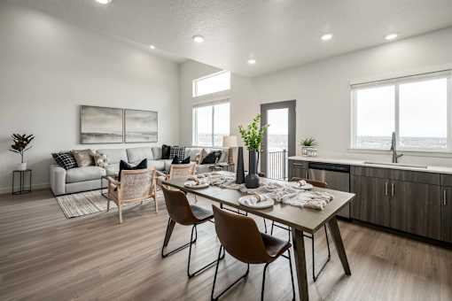 A modern dining room with a wooden table and chairs.