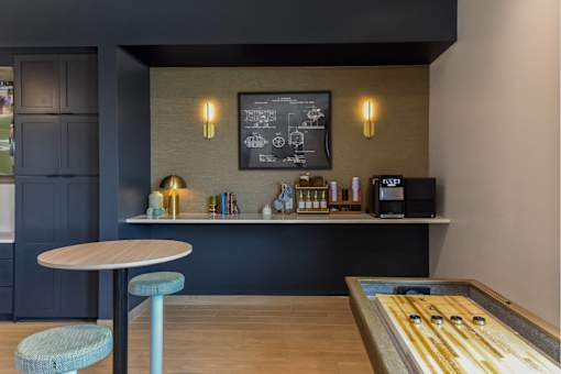 A modern cafe interior with a wooden table and a bar counter.