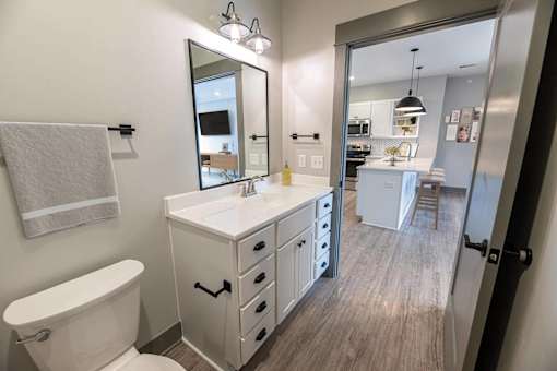 A white bathroom with a white toilet and a white sink.