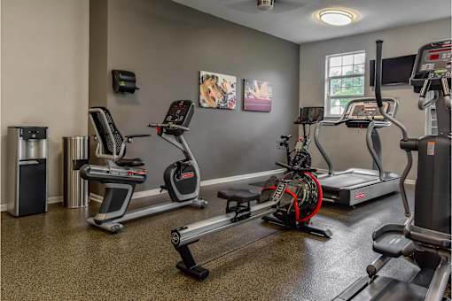 Fitness center with a treadmill and water station at The Villas at Mainstreet apartments in Ann Arbor, MI for rent.