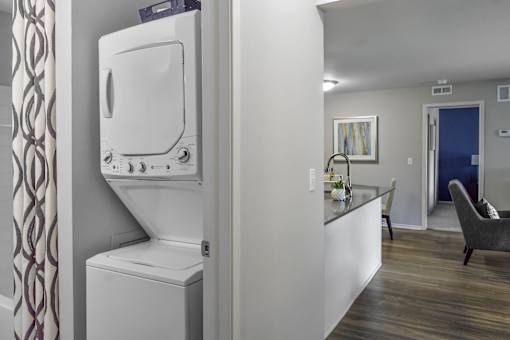 A white washing machine and dryer in a laundry room.