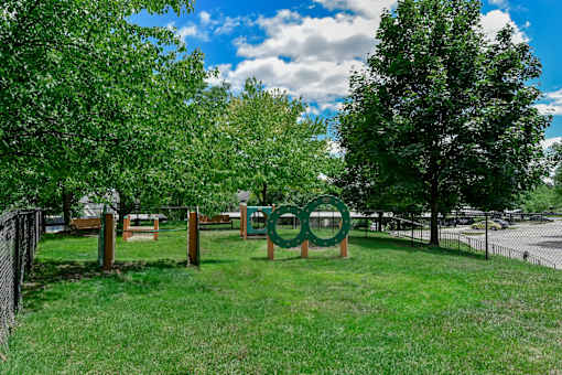 A green sign with the word "Olympic" on it is in the foreground of a grassy area.