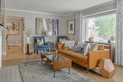 A living room with a blue couch and a coffee table.