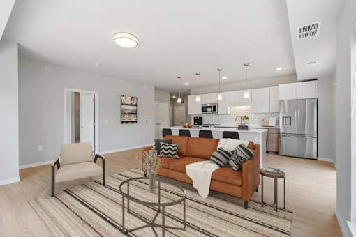 A modern living room with a brown sofa and a coffee table.