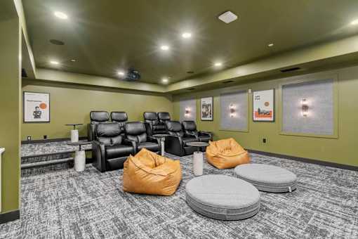 A room with a carpeted floor and a row of chairs.