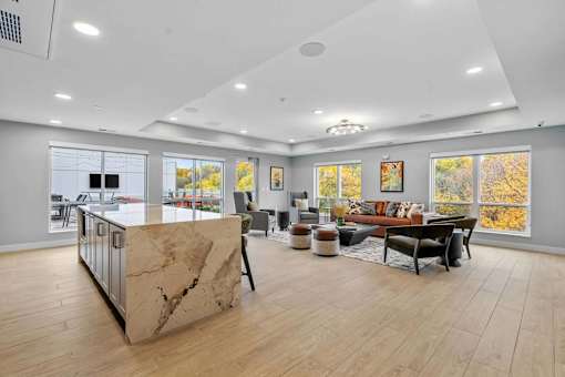 A spacious living room with a marble island in the center.
