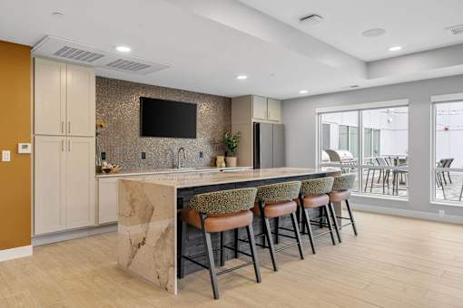 A kitchen with a bar stool and a counter.