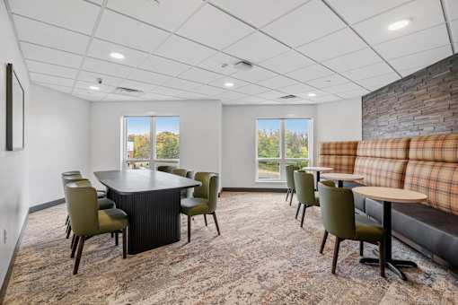 A conference room with a long table and chairs.