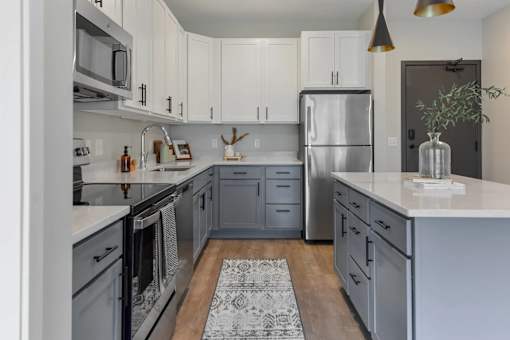 Kitchen with stainless appliances at The Lodge at Overland new apartments in Rochester, MN.