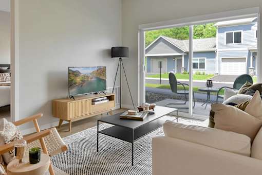 Living room with a patio view at The Lodge at Overland new apartments in Rochester, MN.