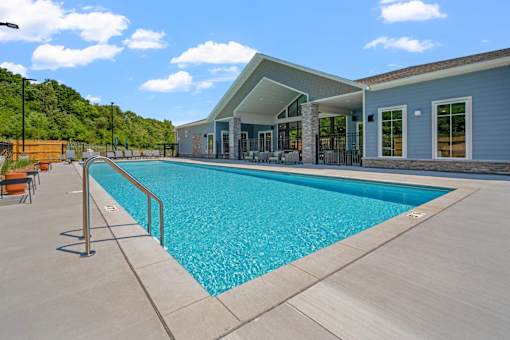 A large swimming pool in front of a building.