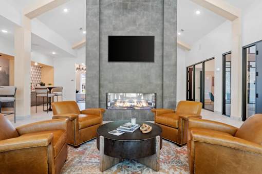 A living room with a fireplace and a television mounted on the wall.