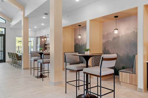 A modern dining area with a table surrounded by chairs.