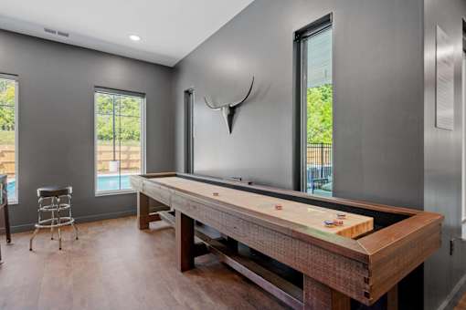 A room with a pool table and a chair.