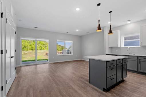 A kitchen with a large island and a view of the backyard.