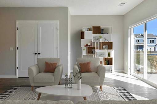 A living room with a white table and two chairs.
