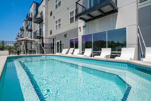 Swimming pool with lounge chairs at The Westlyn luxury apartments in St. Paul, MN
