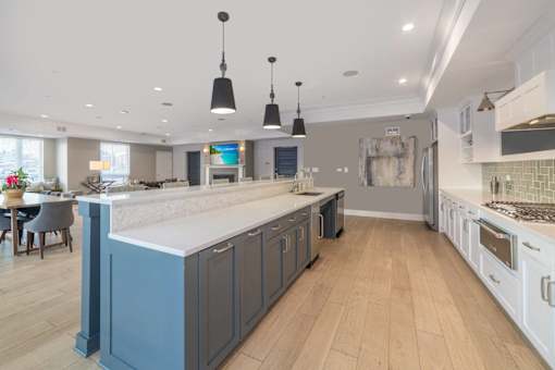 A kitchen with a large island and wooden floors.